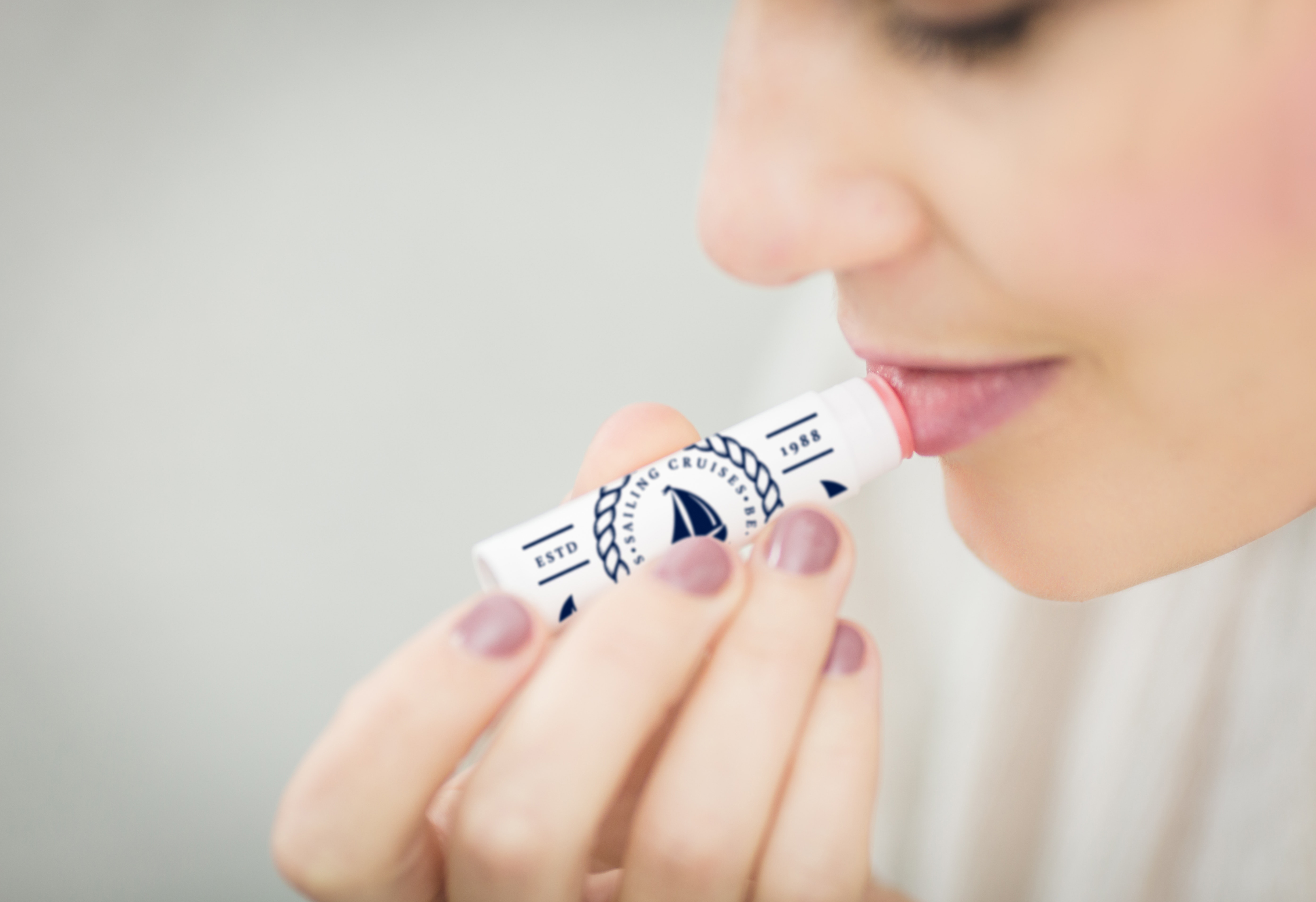 Person applying lip balm with custom printed label